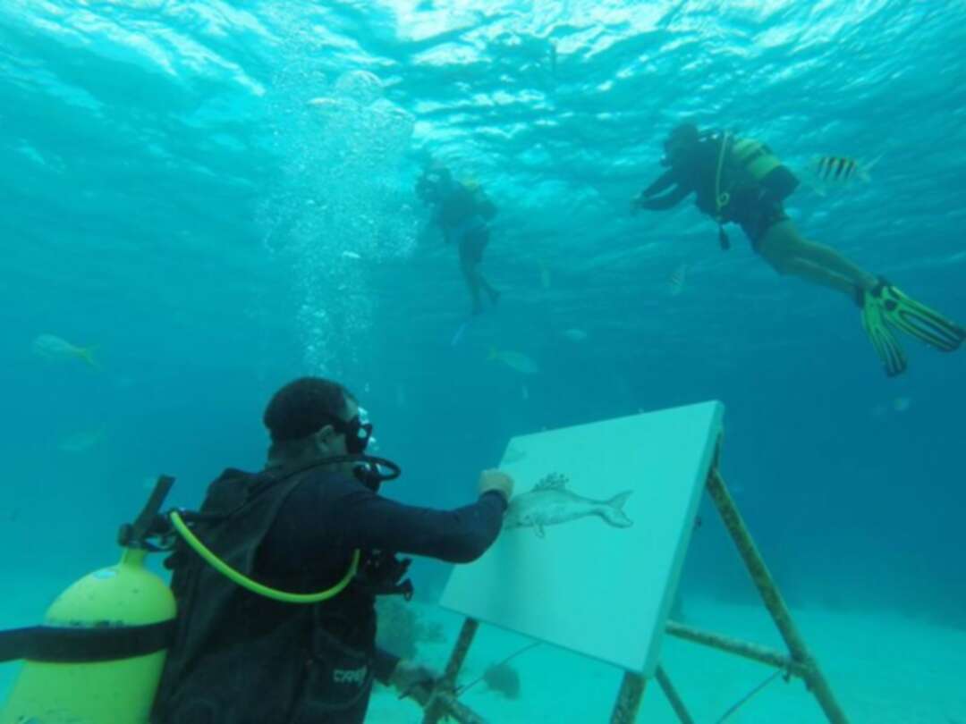 فنان كوبي يرسم لوحاته تحت سطح البحر