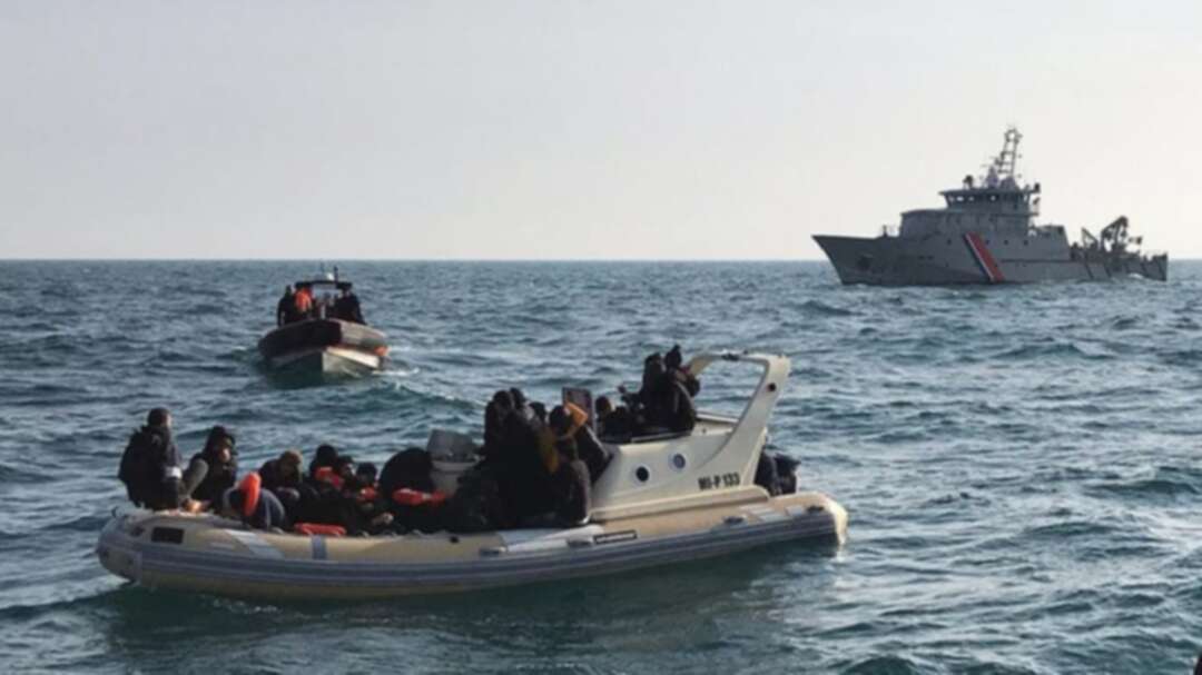British rescuers (front) helping some 20 migrants on a semi-rigid boat trying make their way from France across the English Channel. (File photo: AFP)