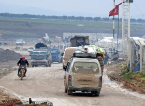 Displaced Syrians flee the countryside of Aleppo and Idlib provinces towards Syria's northwestern Afrin district near the border with Turkey on February 13, 2020. (AFP)