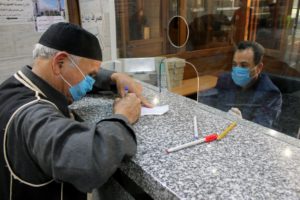 Men wear face masks at a bank in Libya, March 22. (Reuters)