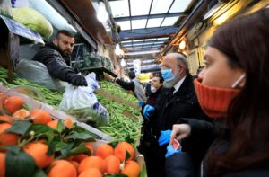 People wearing masks shop at Jerusalem's Mahane Yehuda market on March 19, 2020. (AP)