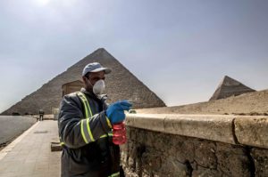 Egyptian municipality workers disinfect the Giza pyramids necropolis on the southwestern outskirts of the Egyptian capital Cairo on March 25, 2020 as protective a measure against the spread of the coronavirus COVID-19.(AFP)