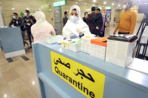 Egyptian Quarantine Authority employees prepare to scan body temperature for incoming travelers at Cairo International Airport to detect coronavirus. (File photo: AFP)