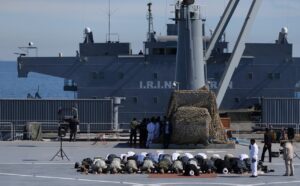 Iranian military commanders and other members of the armed forces pray on the Iranian-made warship Makran during an exercise in the Gulf of Oman. (Reuters)