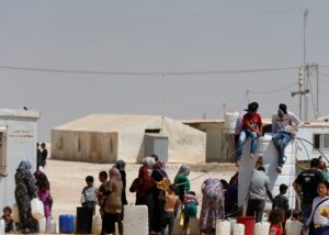 FILE PHOTO: Syrian refugees collect water at the Al-Zaatari refugee camp in Mafraq, Jordan, near the border with Syria August 18, 2016. REUTERS/Muhammad Hamed/File Photo