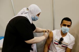A Bahraini man gets a dose of a coronavirus disease (COVID-19) vaccine, at Bahrain International Exhibition & Convention Centre (BIECC), in Manama. (Reuters)