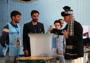 Afghan President Ashraf Ghani, right, casts his vote at Amani high school, near the presidential palace in Kabul, Afghanistan, Saturday, Sept. 28, 2019. Afghans headed to the polls on Saturday to elect a new president amid high security and Taliban threats to disrupt the elections, with the rebels warning citizens to stay home or risk being hurt. (AP Photo/Rahmat Gul)