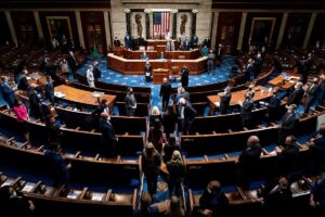 Electoral college votes are brought in before House Speaker Nancy Pelosi and Vice President Mike Pence resume presiding over a Joint session of Congress to certify the 2020 Electoral College results, after supporters of President Donald Trump stormed the Capitol earlier in the day, on Capitol Hill in Washington, US, on January 6, 2021. (Reuters)