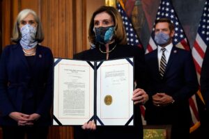 House Speaker Nancy Pelosi of Calif., displays the signed article of impeachment against President Donald Trump in an engrossment ceremony before transmission to the Senate for trial on Capitol Hill, in Washington, Wednesday, Jan. 13, 2021. (AP)