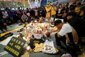 Mourners gather in Microsoft Square near the Staples Center to pay respects to Kobe Bryant after a helicopter crash killed the retired basketball star, in Los Angeles. (Reuters)