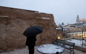 A Jewish man prays in Jerusalem's Old city on a snowy morning in the city, February 18, 2021. (Reuters)