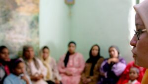 A counsellor talks to a group of women to try to convince them that they should not have FGM (Female Genital Mutilation) performed on their daughters in Minia, Egypt June 13, 2006. (Reuters)