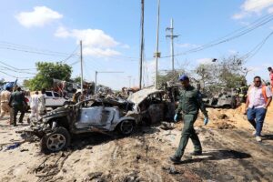 A Somali police officer walks past a wreckage at the scene of a car bomb explosion at a checkpoint in Mogadishu, Somalia. (File photo: Reuters)