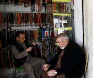 An Iraqi man sells rosaries at a shop in Fallujah, Iraq February 3, 2021. (Reuters)
