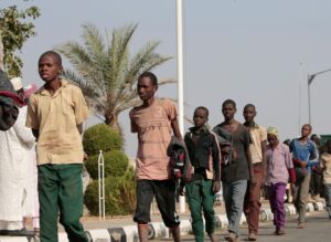 Freed Nigerian schoolboys walk after they were rescued by security forces in Katsina, Nigeria on December 18, 2020. (Reuters)