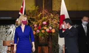 Liz Truss attends a signing ceremony with the Japanese foreign minister, Toshimitsu Motegi, on an economic partnership between Japan and Britain.