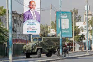 Security forces block a street with an armored personnel carrier during protests against the government and the delay of the country's election in the capital Mogadishu, Somalia, Feb. 19, 2021. (AP)