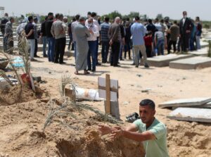 Palestinian worker Mohammad al-Haresh, 30, digs a grave for a coronavirus disease (COVID-19) victim, at a cemetery, east of Gaza City April 20, 2021. Picture taken April 20, 2021. (Reuters)
