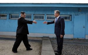 North Korea's leader Kim Jong Un (L) shakes hands with South Korea's President Moon Jae-in (R) at the Military Demarcation Line that divides their countries ahead of their summit at the truce village of Panmunjom on April 27, 2018.(AFP PHOTO / Korea Summit Press Pool / Korea Summit Press Pool)