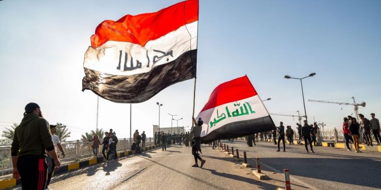 Iraqis waving with Iraq flag-