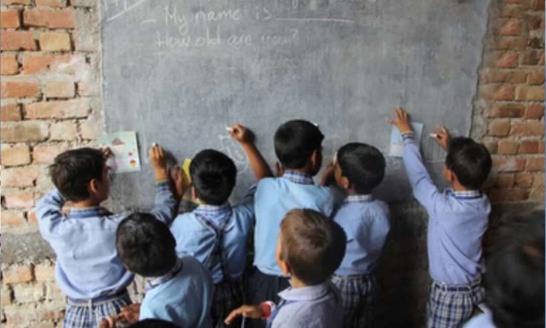 Indian teacher turns walls into blackboards and roads into classrooms to close school gap