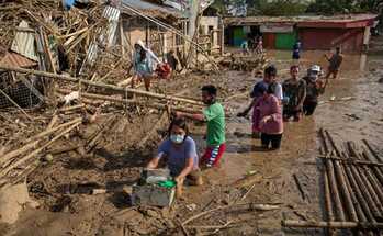 Residents retrieve belongings from their submerged village after Typhoon Vamco.