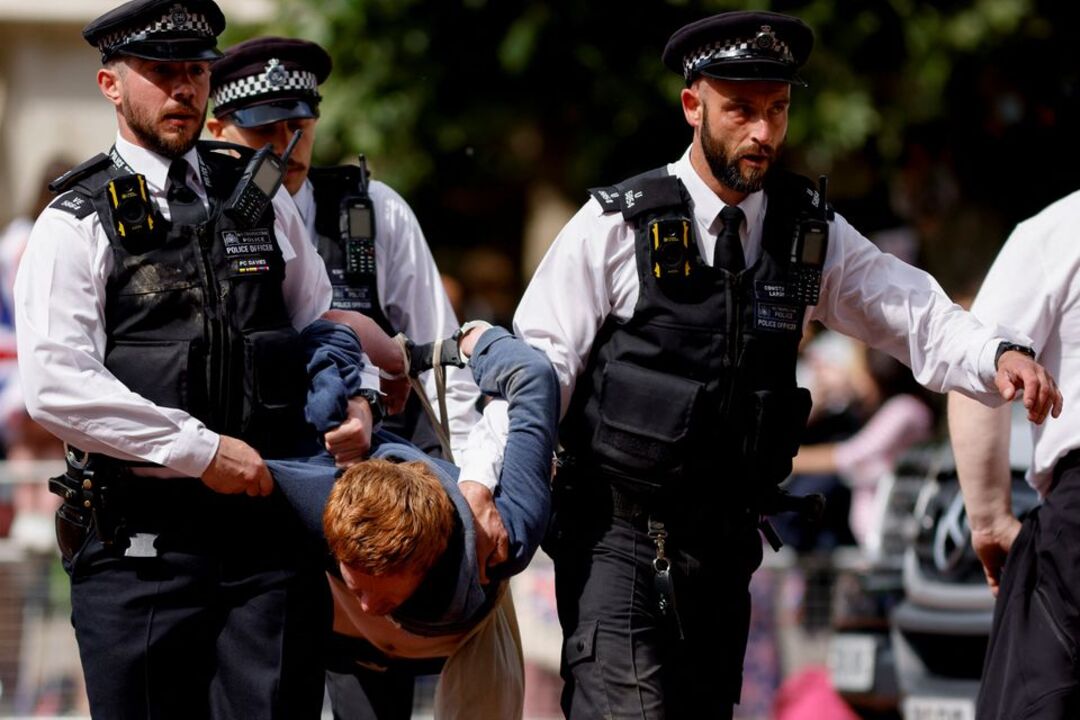 Twelve arrested after climate change protesters disrupt Queen Elizabeth's military parade